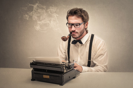 Young writer smoking the pipeの写真素材