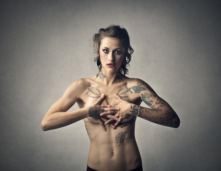 Naked tattooed womanの写真素材