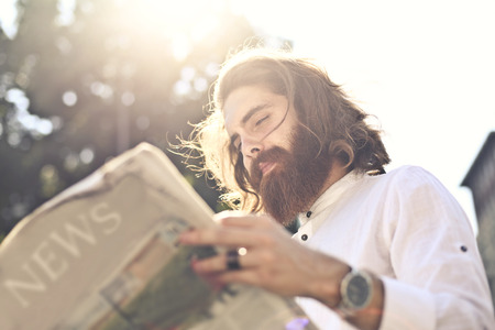Hipster reading the newspaperの写真素材