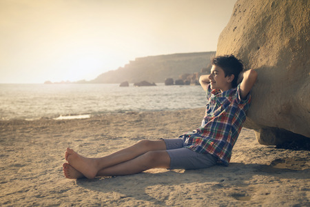 Relaxed kid at the beachの写真素材