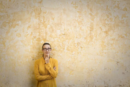 Young girl by the wallの写真素材