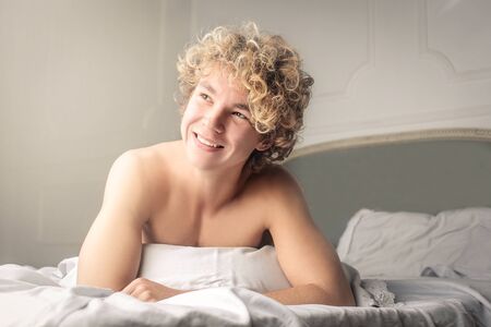Young man with curly hairの写真素材