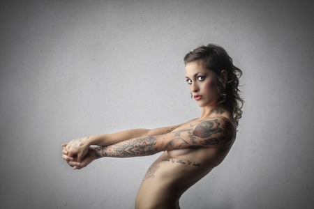 Nude sexy woman with tattoosの写真素材