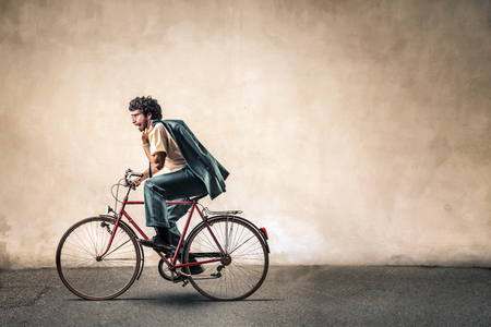 Businessman is riding a bikeの写真素材