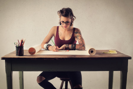 Tattooed woman at the tableの写真素材