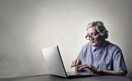 Old man is using the computerの写真素材
