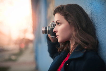 Woman is taking a pictureの写真素材