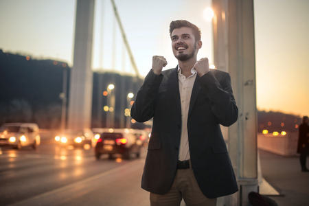 Happy businessman on the bridgeの写真素材