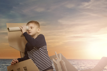 Little child on a paper boatの写真素材