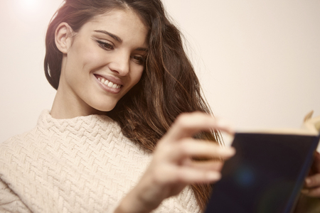 Beautiful woman is reading a bookの写真素材