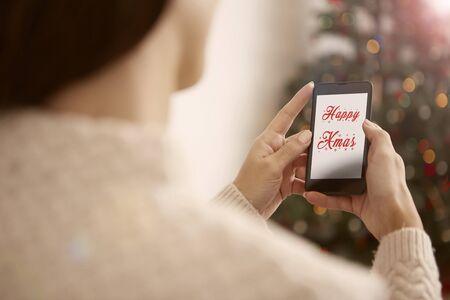 A woman is sending a Christmas message