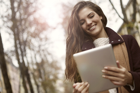 Smiling woman with a tabletの写真素材