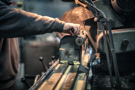 Working with metal in a factoryの写真素材