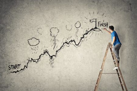 A creative man is drawing on the wallの写真素材