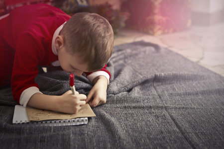 Little boy is writing a letter to Santaの写真素材
