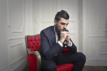 Handsome businessman is thinkingの写真素材