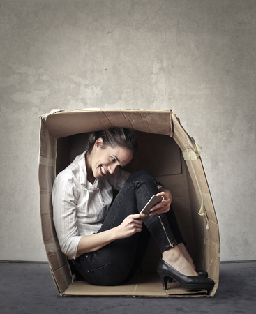 A businesswoman in a box made from paperの写真素材