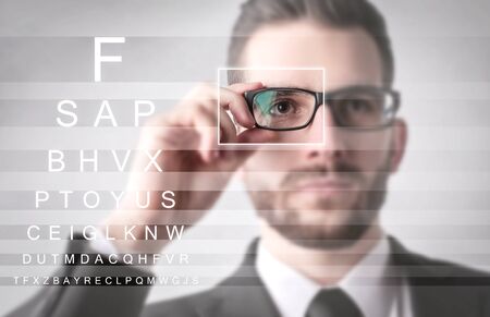 Businessman Trying to read well with his new glassesの写真素材