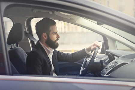 Handsome businessman is driving a carのeditorial素材