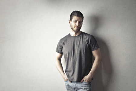 Young guy next to a gray wallの写真素材