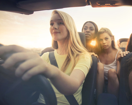 Young girls are going to a trip with a carの写真素材