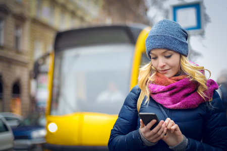 The girl and the tram in the cityの写真素材
