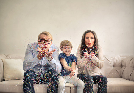 Family is having fun with confettiの写真素材