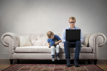 Father and child on the sofaの写真素材