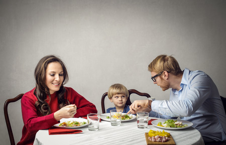 Happy family is having dinner whenの写真素材