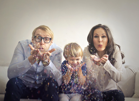 Family is playing with confettiの写真素材