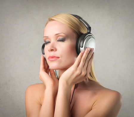 Naked woman in big headphonesの写真素材