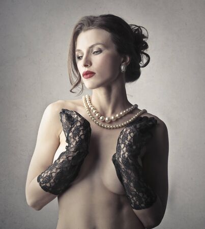 naked woman in black glovesの写真素材