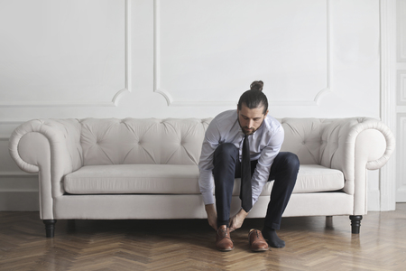 Businessman is taking his shoes onの写真素材