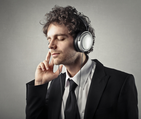 Businessman is enjoying musicの写真素材