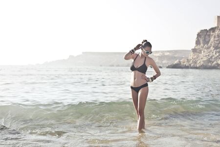 Girl is posing in a bikini at the seaの写真素材
