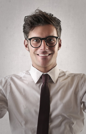 Young and happy businessman in glassesの写真素材