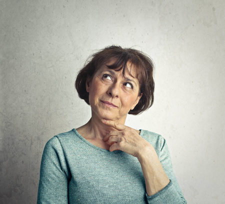 Middle aged woman is thinkingの写真素材