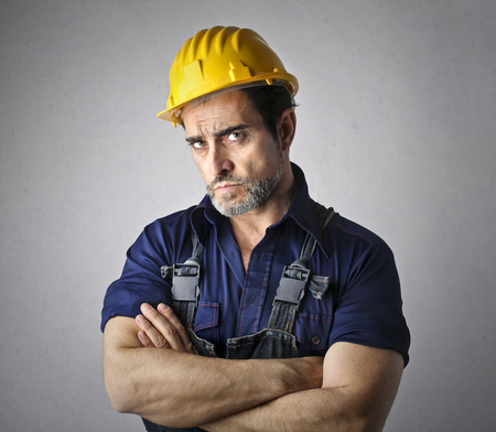 Man worker in a yellow helmet