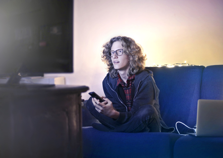 Guy watching television at home