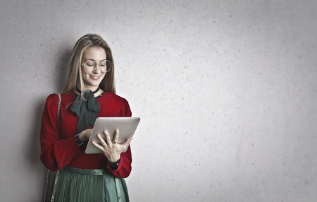 A portrait of an elegant girl with a tabletの写真素材
