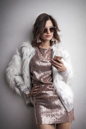 portrait of an elegant woman with a smartphoneの写真素材