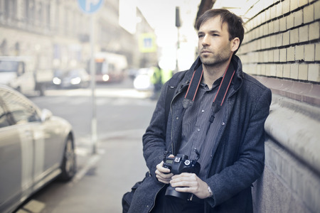 Man with a camera in a city streetの写真素材