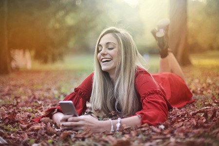Girl using a smartphone in a natural contextの写真素材