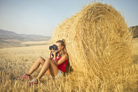 Girl thing to photo in the countrysideの写真素材