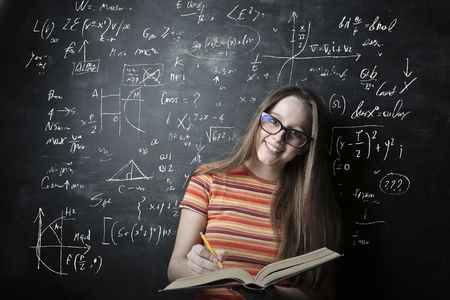 Student girl in front of a blackboardの写真素材
