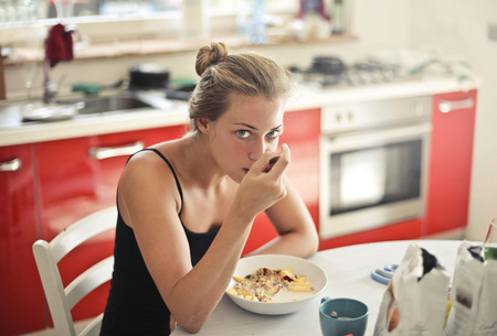 Girl having breakfast at homeの写真素材