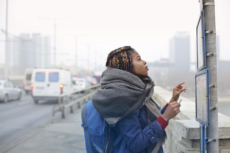 Girl looking at the bus on the busの写真素材