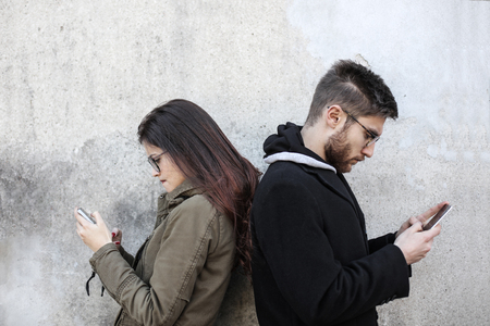 A man and a woman using smartphonesの写真素材
