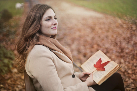 Girl with a book in a parkの写真素材