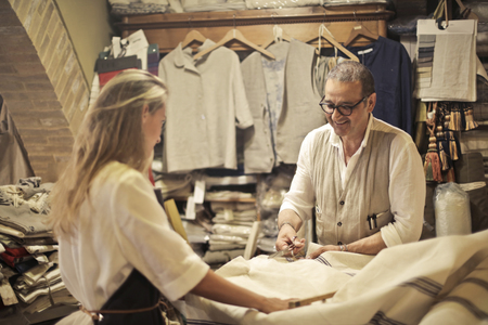 Two artisans at work with fabricsの写真素材